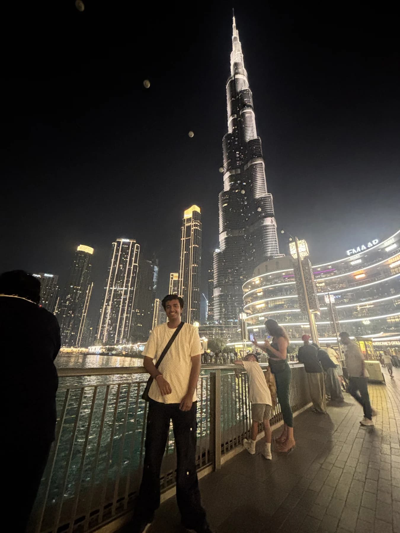 Rakshit standing in front of a city skyline at night