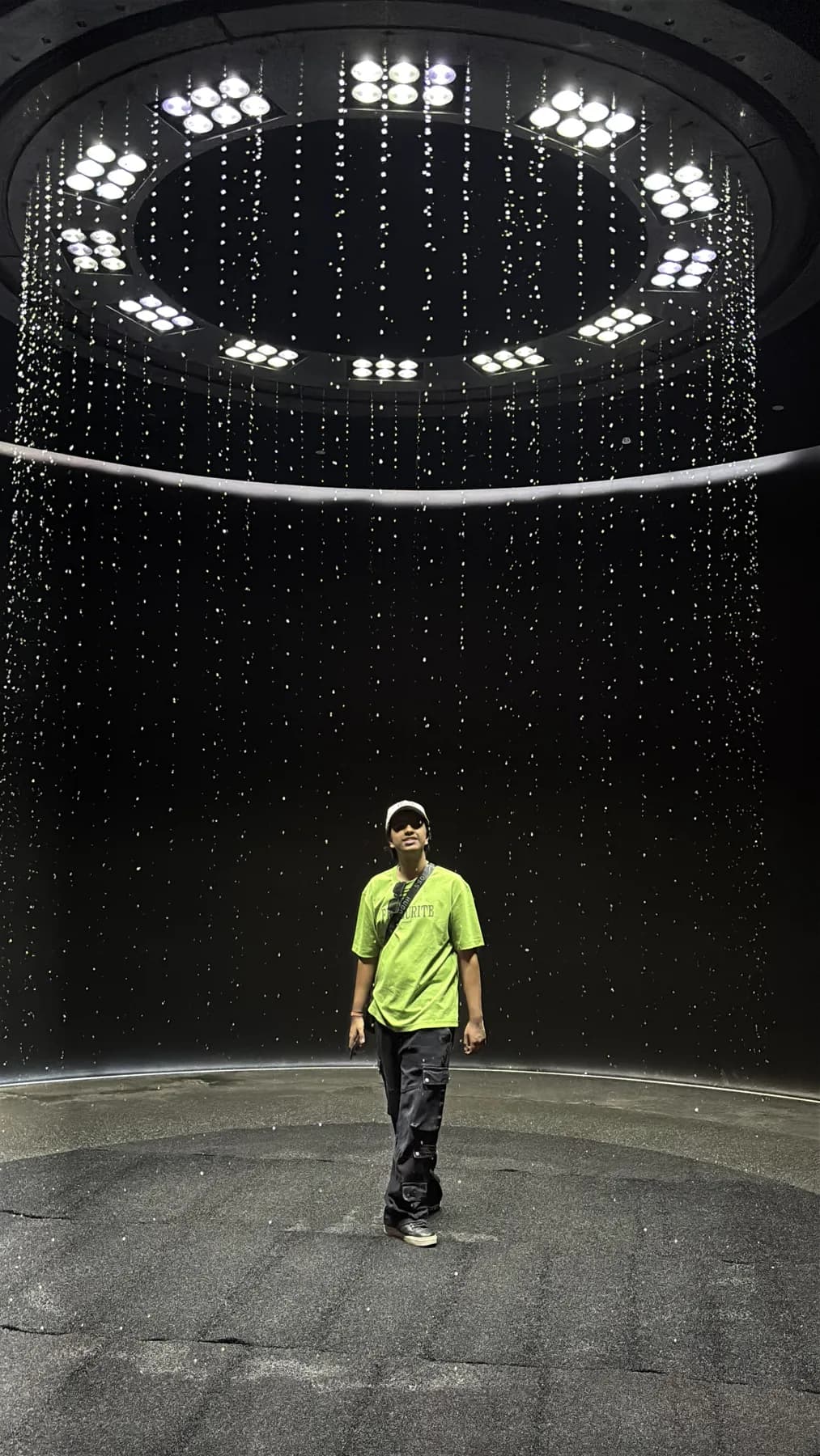 Rakshit under a ring of lights at a creator venue